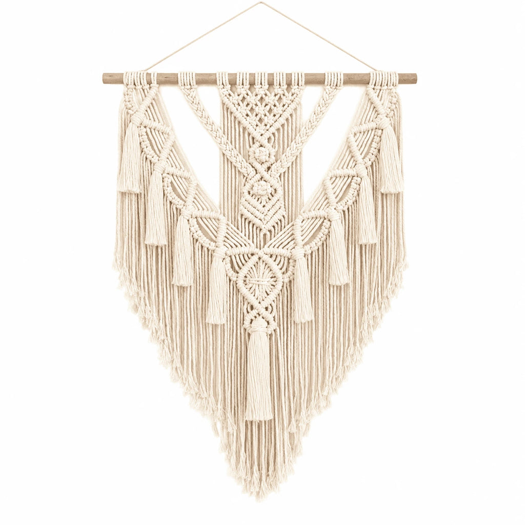 Hammora Solstice macrame wall hanging in cream cotton with geometric V-pattern and cascading fringe on white background
