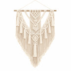 Hammora Solstice macrame wall hanging in cream cotton with geometric V-pattern and cascading fringe on white background