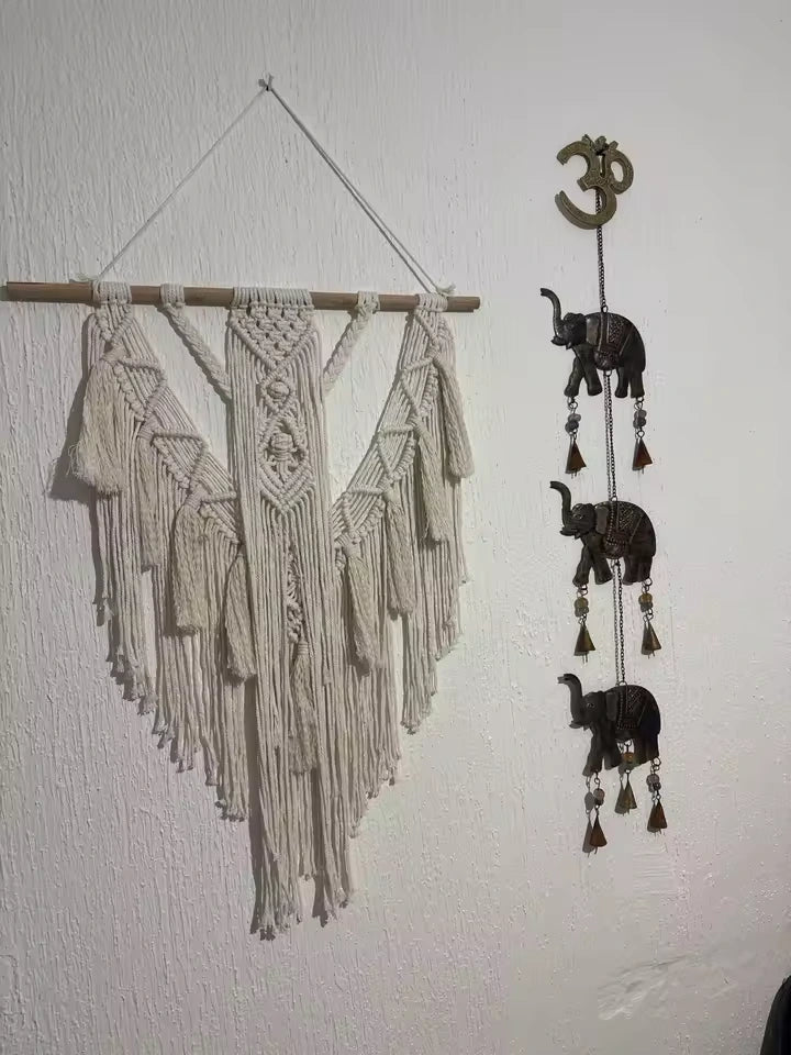 Close-up detail of hand-knotted cotton cord and natural wood dowel on the Hammora Solstice wall hanging